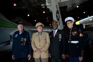Several of the Dallas Veterans Day Parade grand marshals, from left, James Henderson, William Morris Paulk, Will H. Nealy and R.V. Burgin, pose on Wednesday at the Frontiers of Flight Museum in Dallas. (Rachel Woolf/The Dallas Morning News)